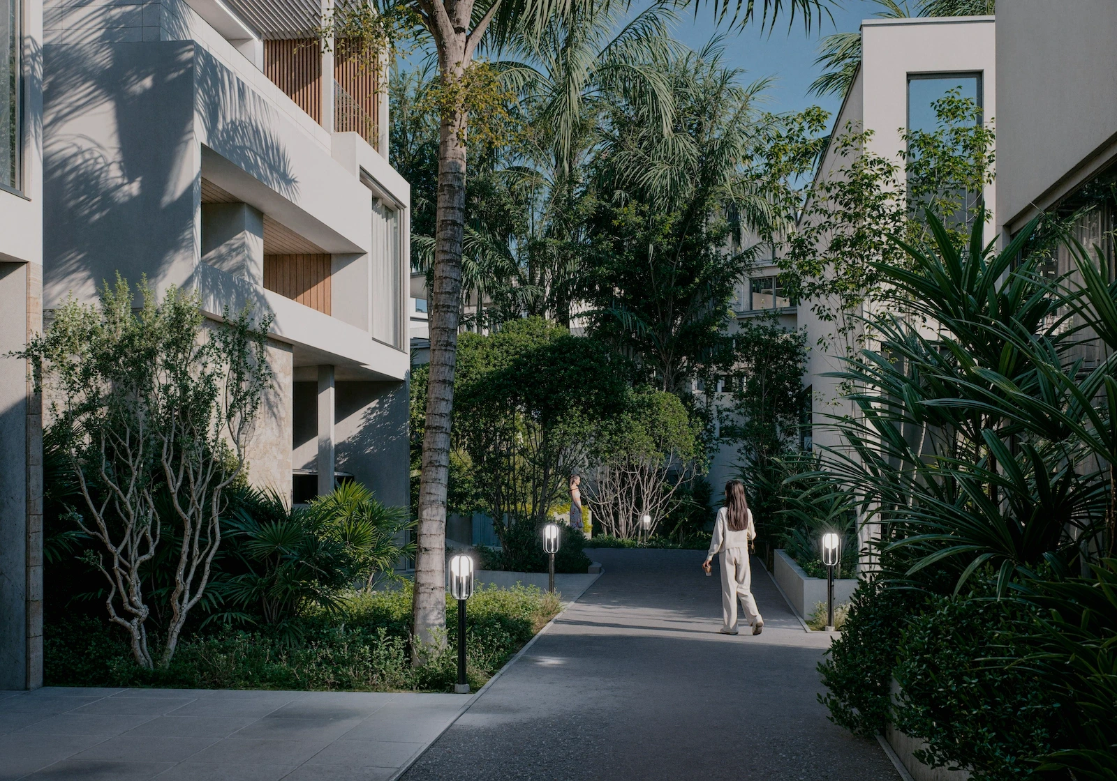 IO Villas — courtyard with tropical landscaping and pathway lighting