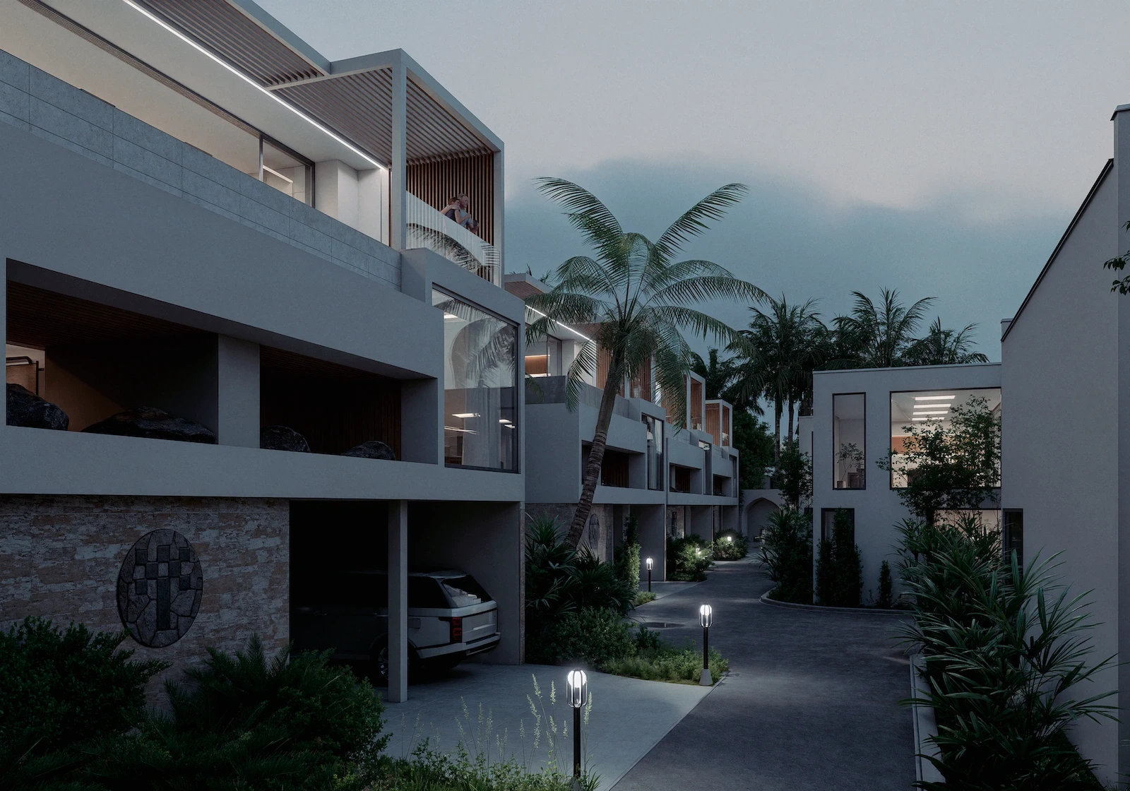 IO Villas — evening view of villa street with palm trees