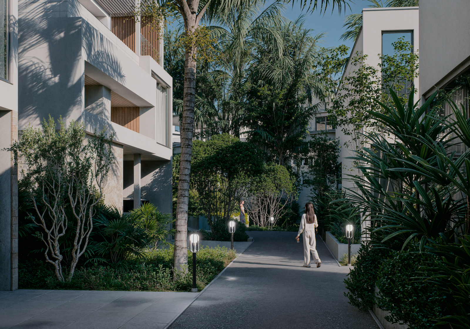 IO Villas — courtyard pathway with tropical landscaping and lanterns